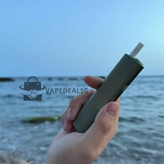 IQOS ILUMA ONE heated tobacco device in hand using TEREA sticks Singapore